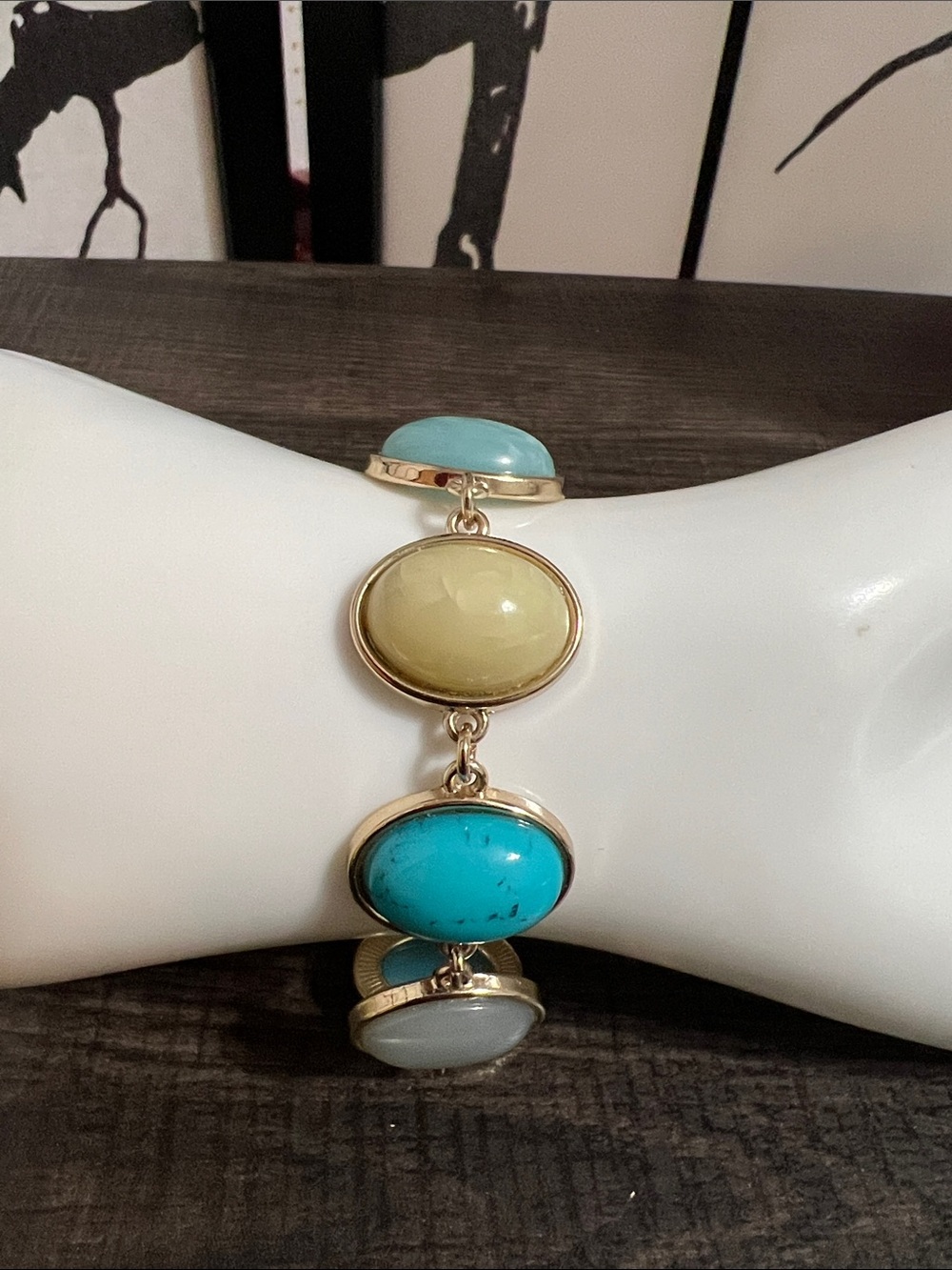 Gold-tone link bracelet featuring bezel-set, oval cabochon faux stones
